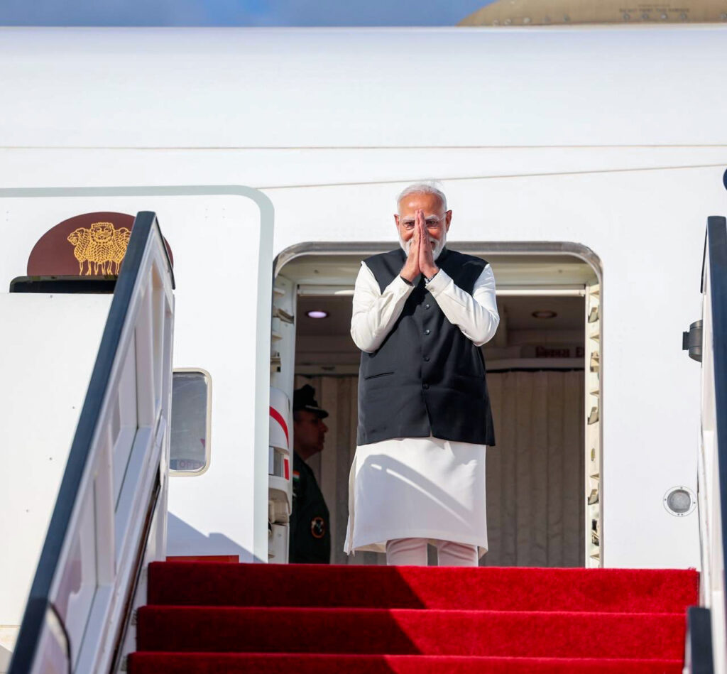Prime Minister Narendra Modi greets as he departs after concluding his state visit